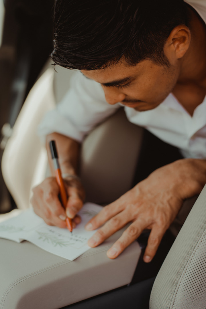Overland elopement Japan - Groom writing his vows
