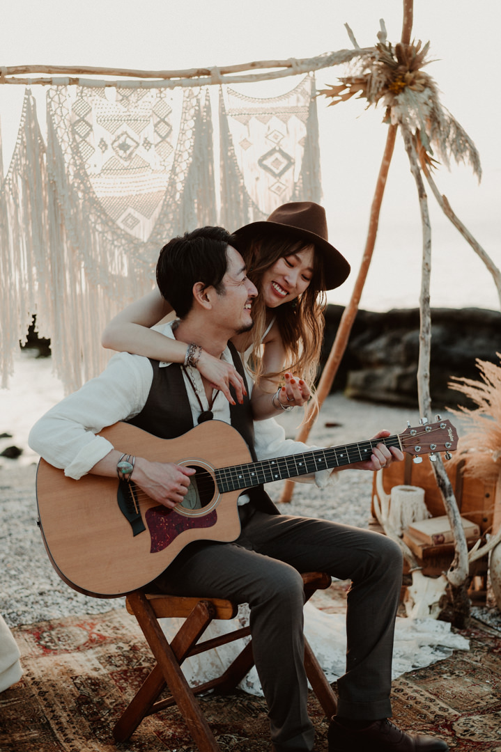 Playing guitar to his girl during Boho elopement in Japan 