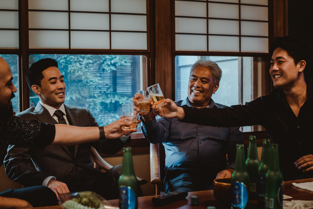 Guys drinking while girls get ready
