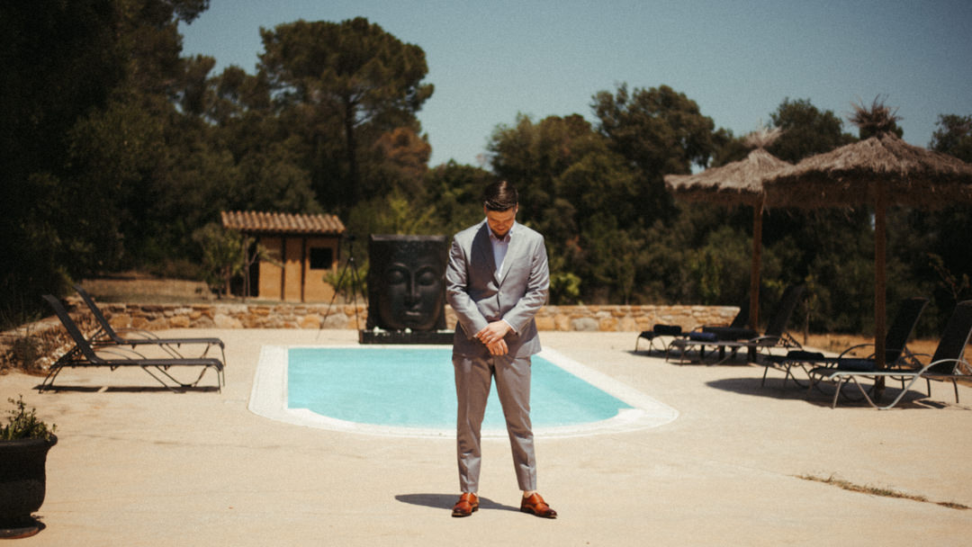 Elope in Barcelona - Groom awaiting first look by the swimming pool