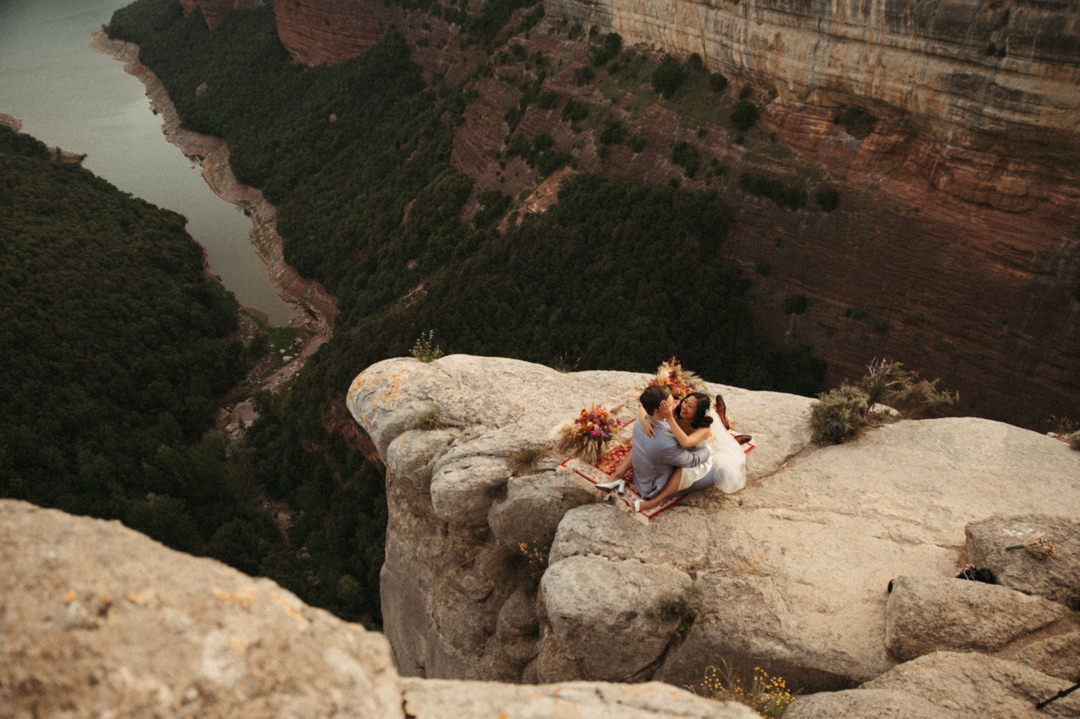 Elope in Barcelona - Couple sitting at the cliff