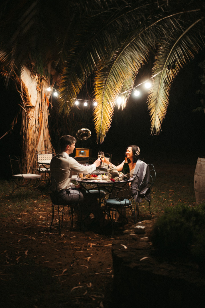 Elope in Barcelona - Couple having candlelight dinner in the garden