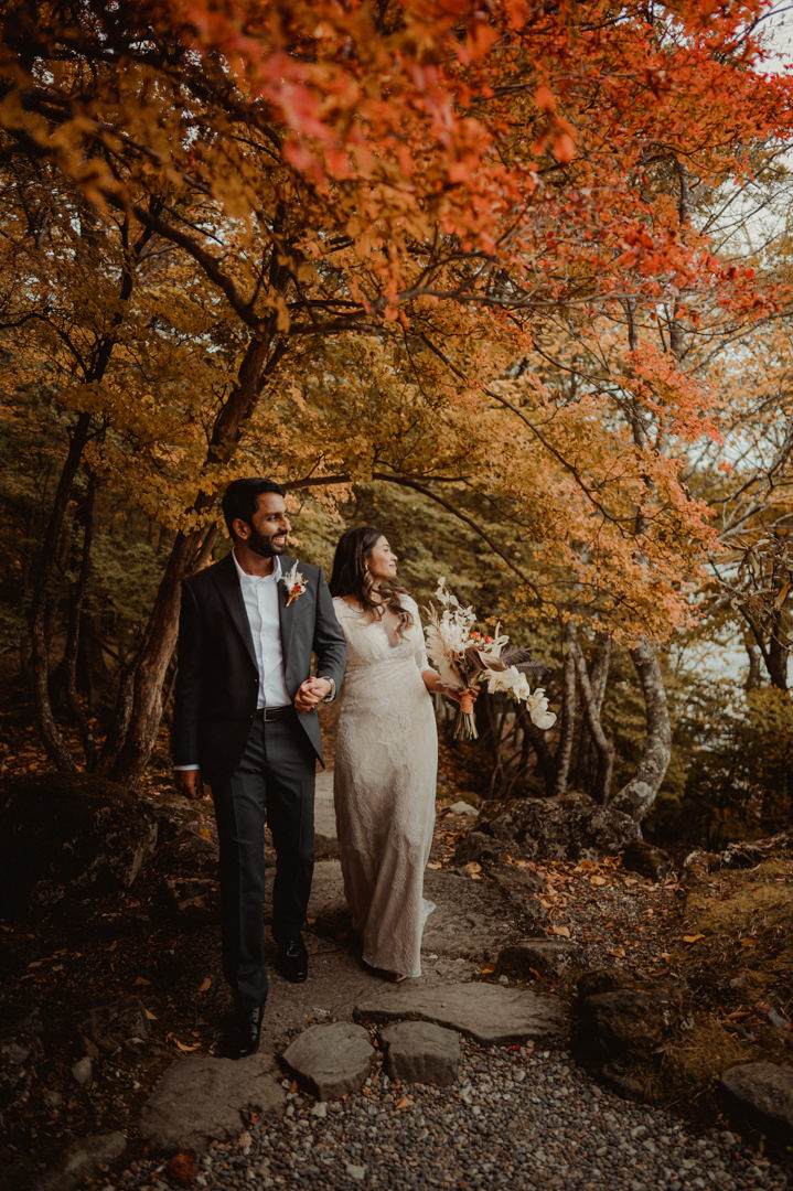 Couple walking in the forest on their fall elopement in Japan