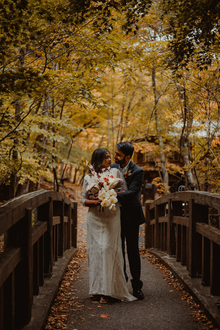 Couple on the Japanese bridge in the wedding dress during their fall elopement in Japan