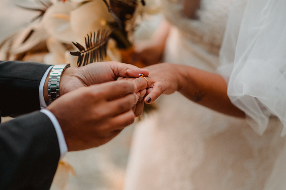 Groom putting a ring on a bride's finger on their fall elopement in Japan