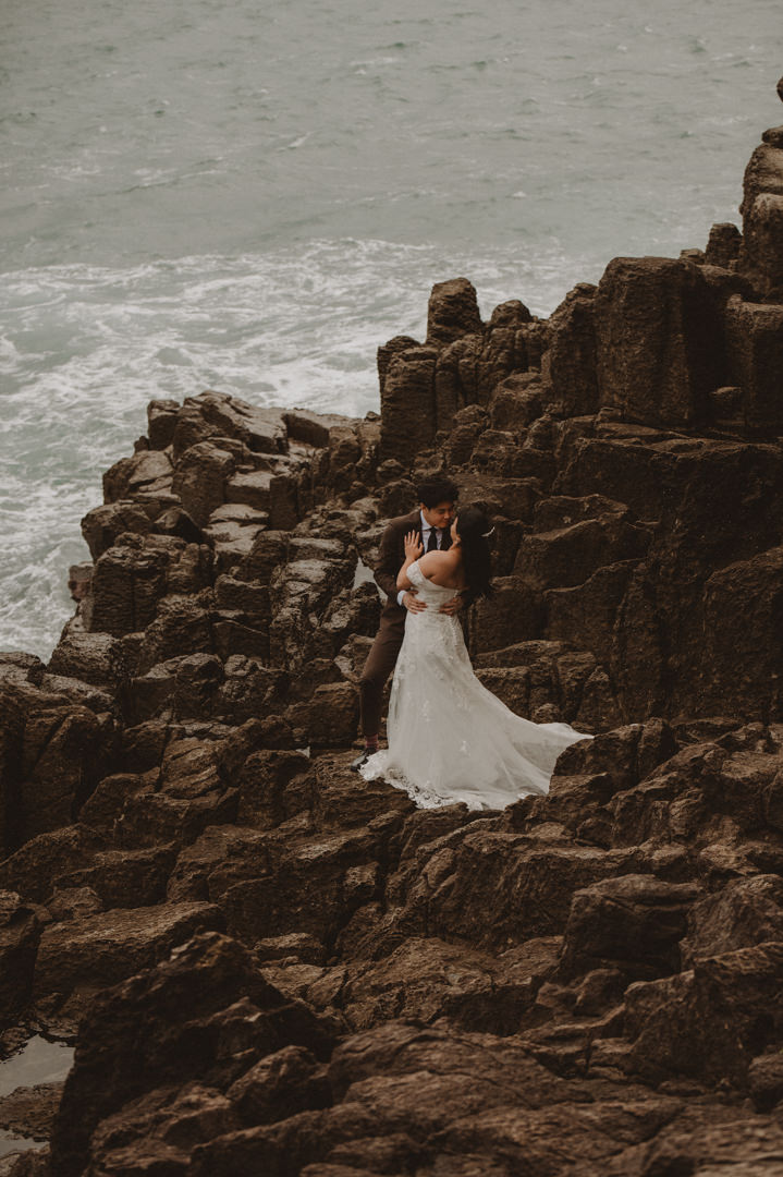 Japan Roadtrip Elopement - Couple is holding each other on the cliff