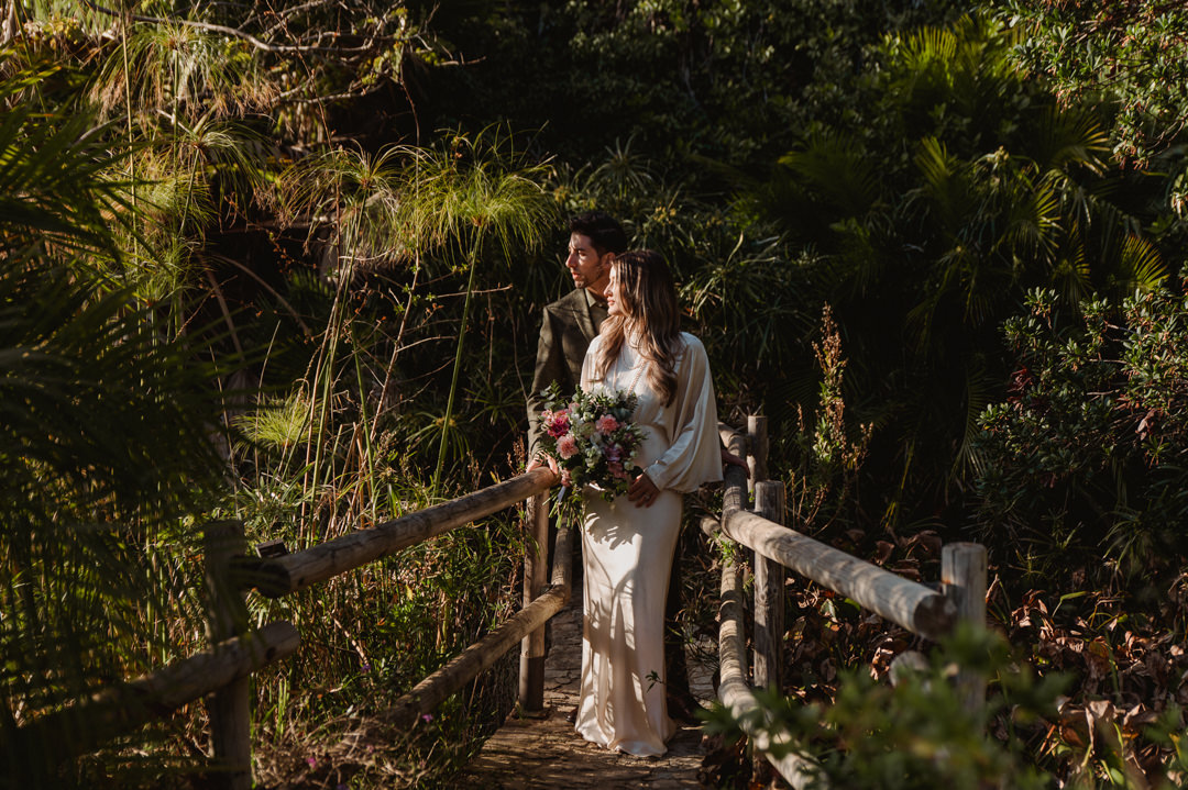 marimurtra elopement - couple standing on the bridge in botanical garden 