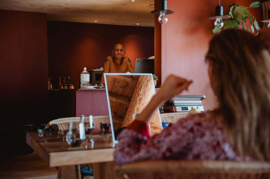 Surfer Elopement in Japan - Groom is watching bride over the kitchen counter