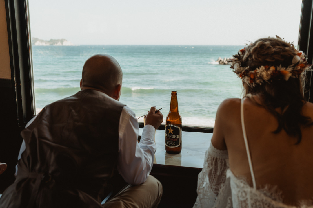 Surfer Elopement in Japan - Couple eating at a local restaurant overlooking the ocean