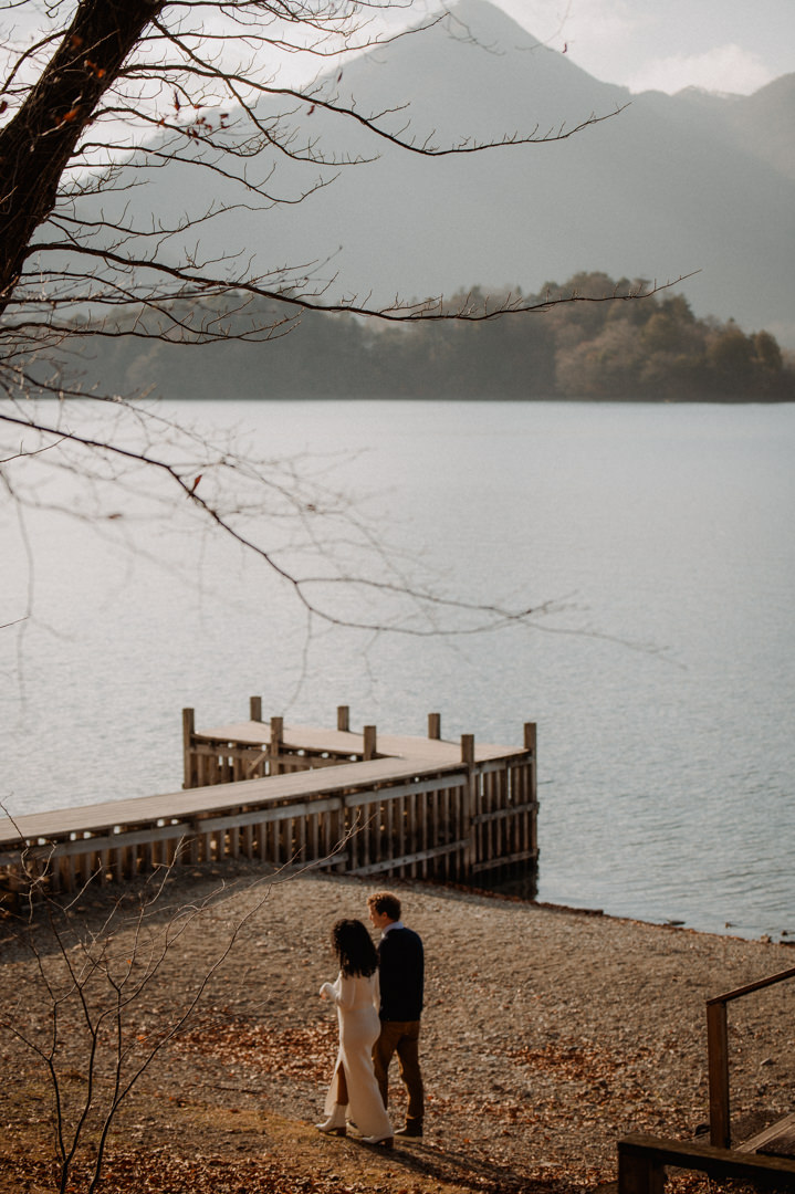 laid-back elopement in japan - couple walking along the lake