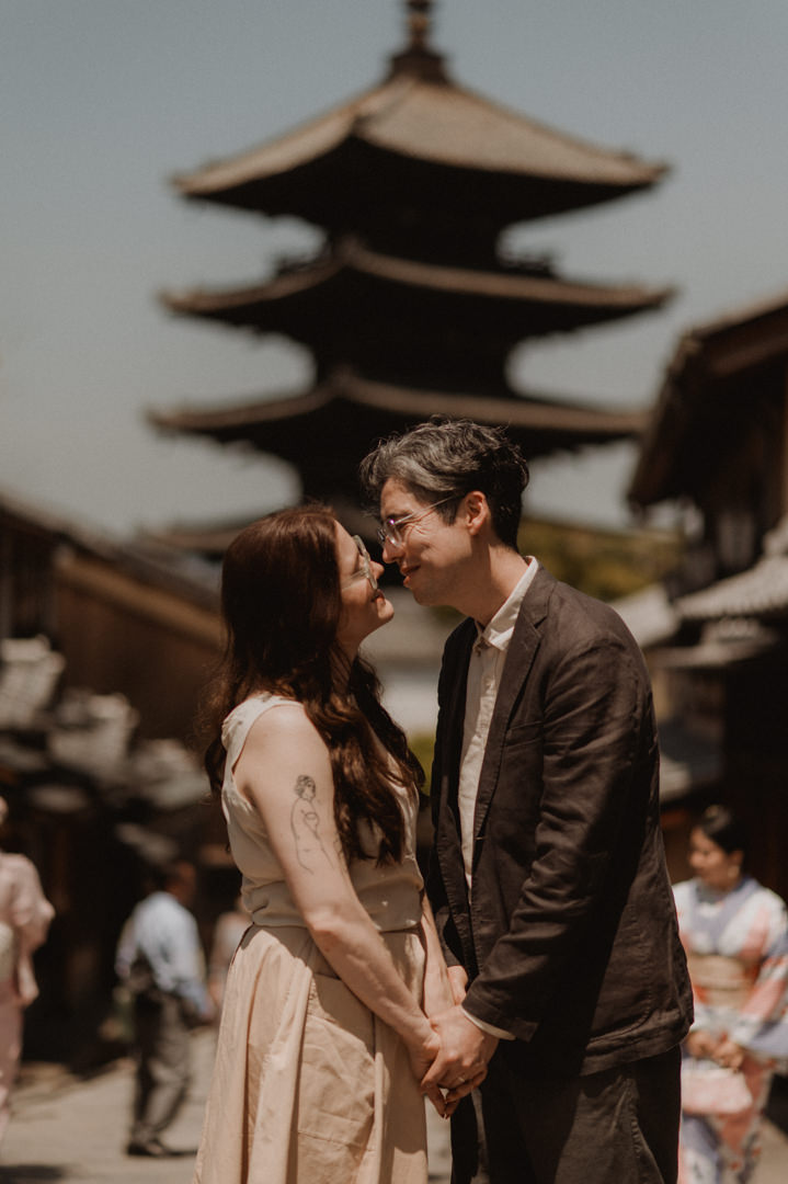 low-key elopement in Japan - couple looking each other in front of the pagoda