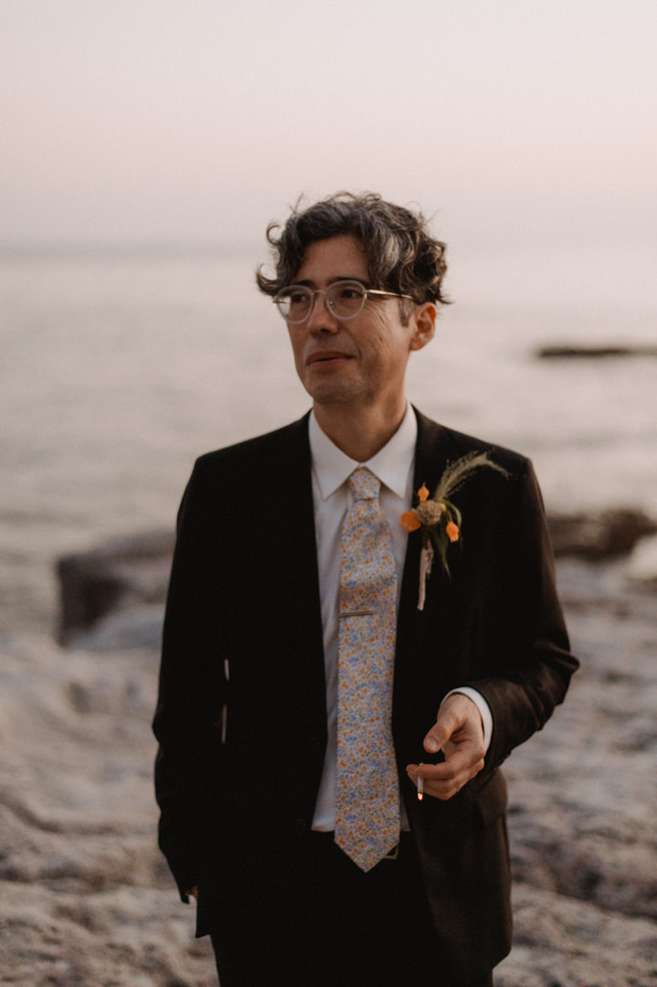 low-key elopement in japan - groom having a tobacco  