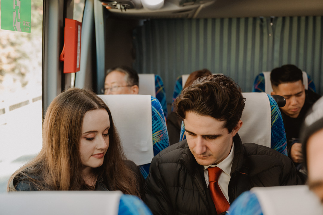 The couple takes a bus to get to Kami Kouchi. Autumn-foliage-elopement-in Japan