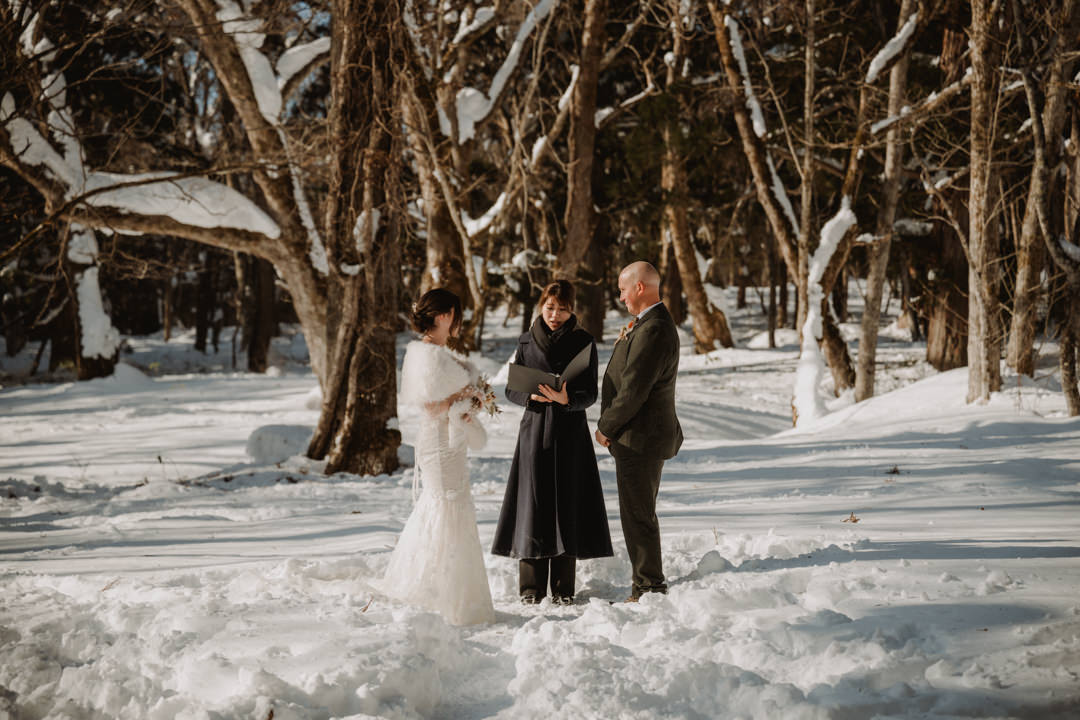 The couple has the ceremony at the shrine. Nagano Snow Elopement