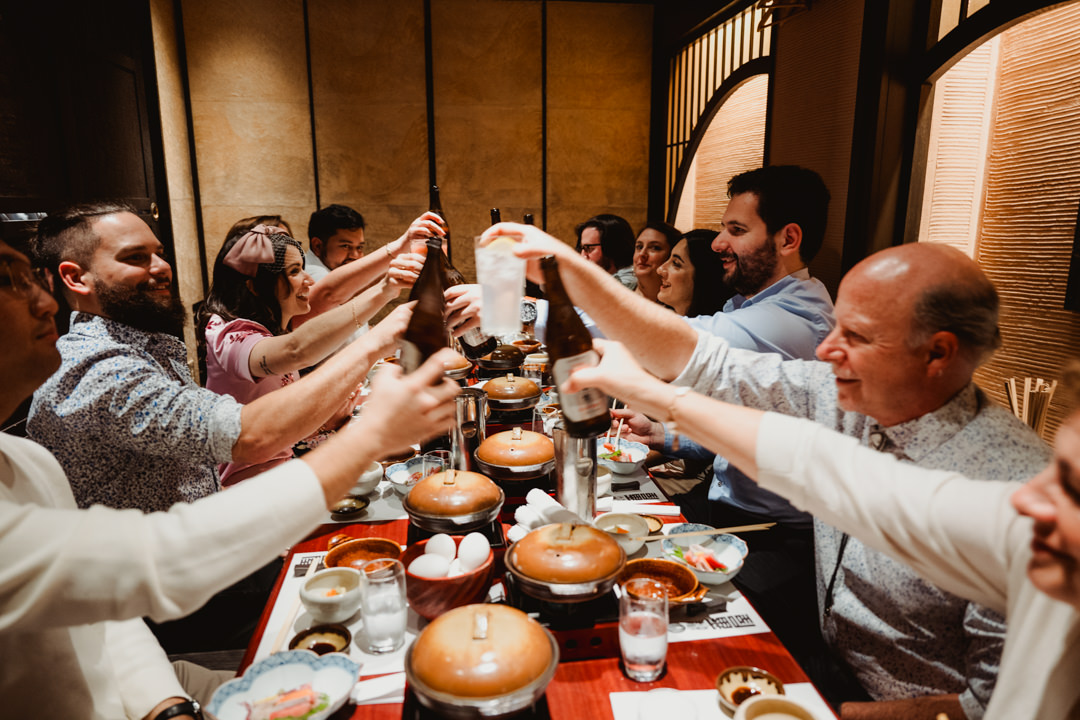 The couple have the dinner with their guests, roof top elopement in Japan