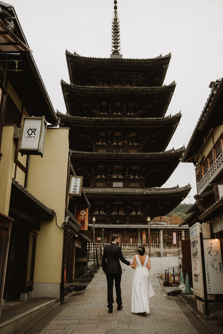 The couple takes a photo in Kyoto city, a private garden elopement in Kyoto 
