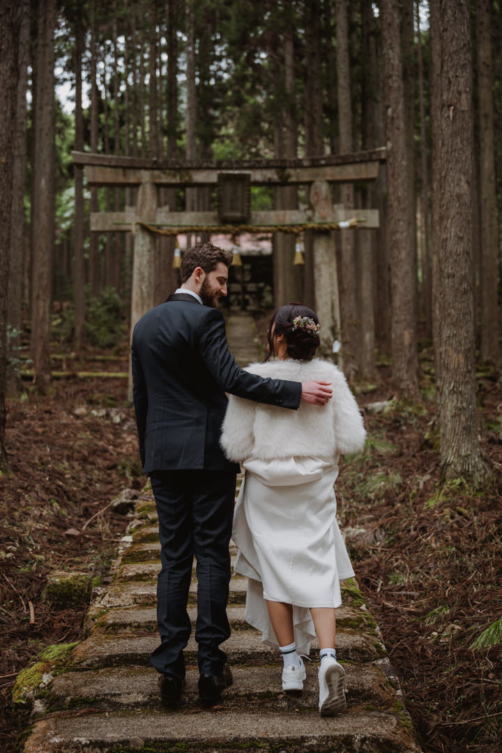 The couple takes a photo at hidden shrine, a private garden elopement in Kyoto 