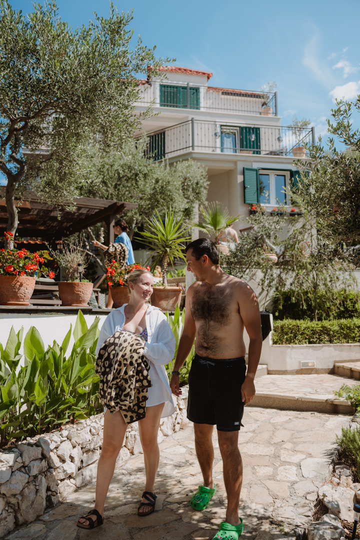 The couple enjoys swimming with their friends, a Adriatic sea elopement in Croatia